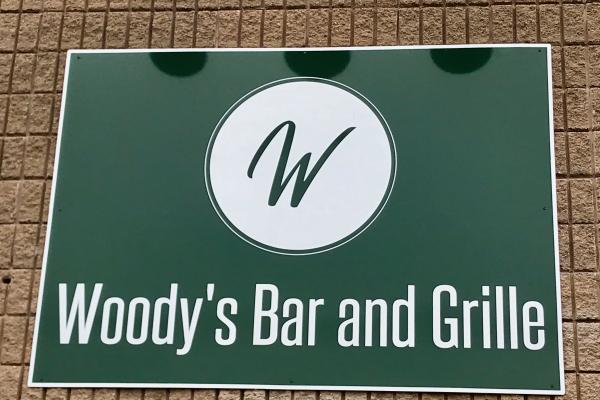 woody bar & grille sign