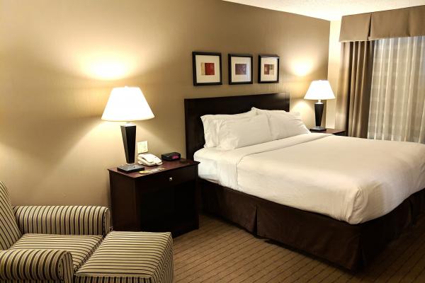 hotel room, bed and lamp and nightstand.