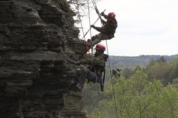 Two members of the Finger Lakes Scaling Team remove loose rock from above the Gorge Trail at Robert H. Treman State Park.