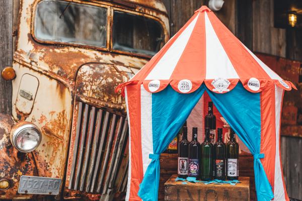 Carnival tent filled with bottles of Bagg Dare wine