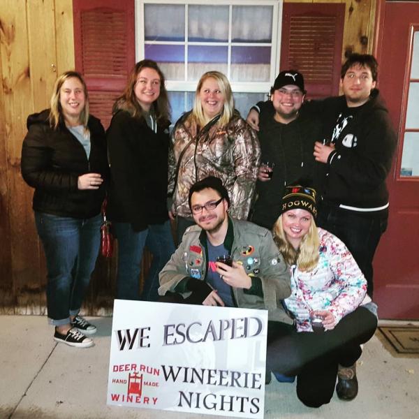 Deer Run Winery customers holding a sign saying We Escaped