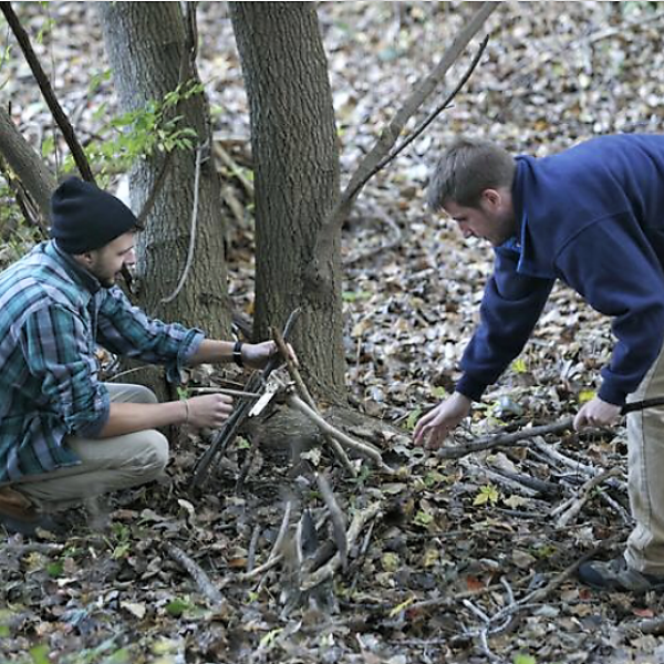 Two men collecting kindling 