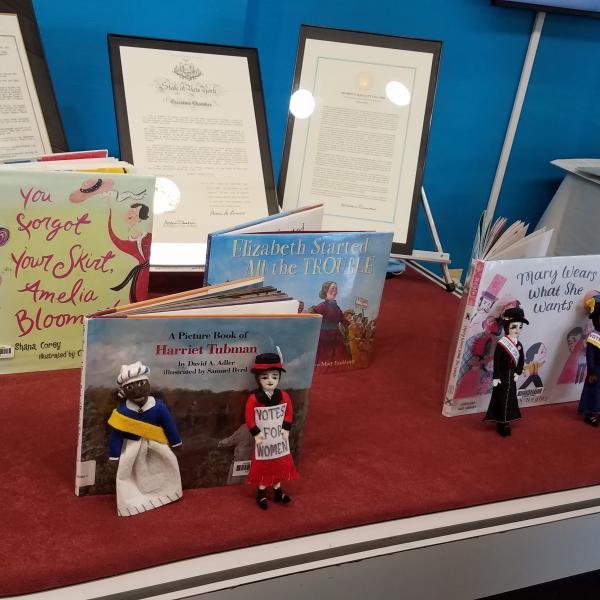 A red table with various children's books displaying different parts of history.