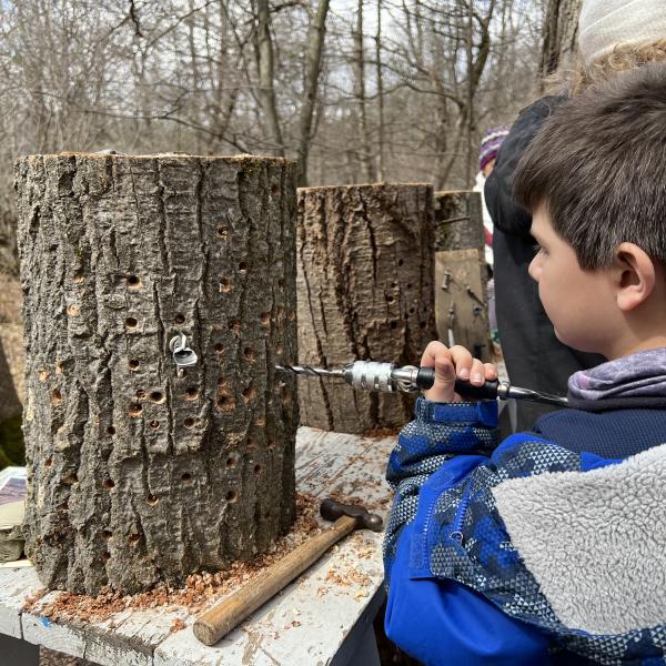 A child trying out the hand drill during the trail demonstrations