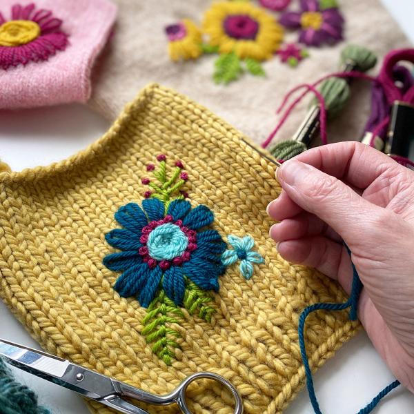 Yellow knitted swatch with a flower embroidery