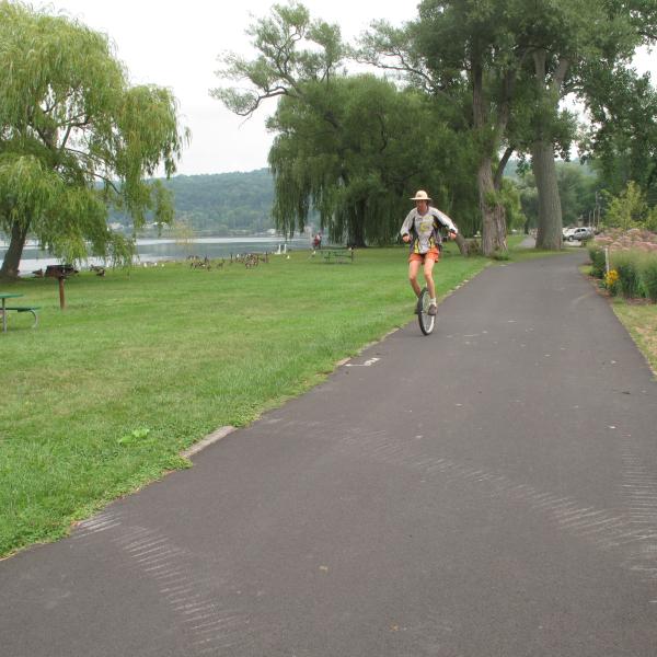 A unicyclist In Stewart Park along the Cayuga Waterfront Trail in Ithaca