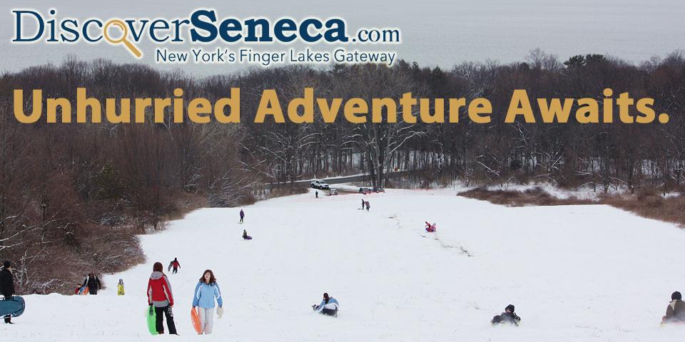discover seneca gold text logo at top left and people skiing on landscape hill throughout image 